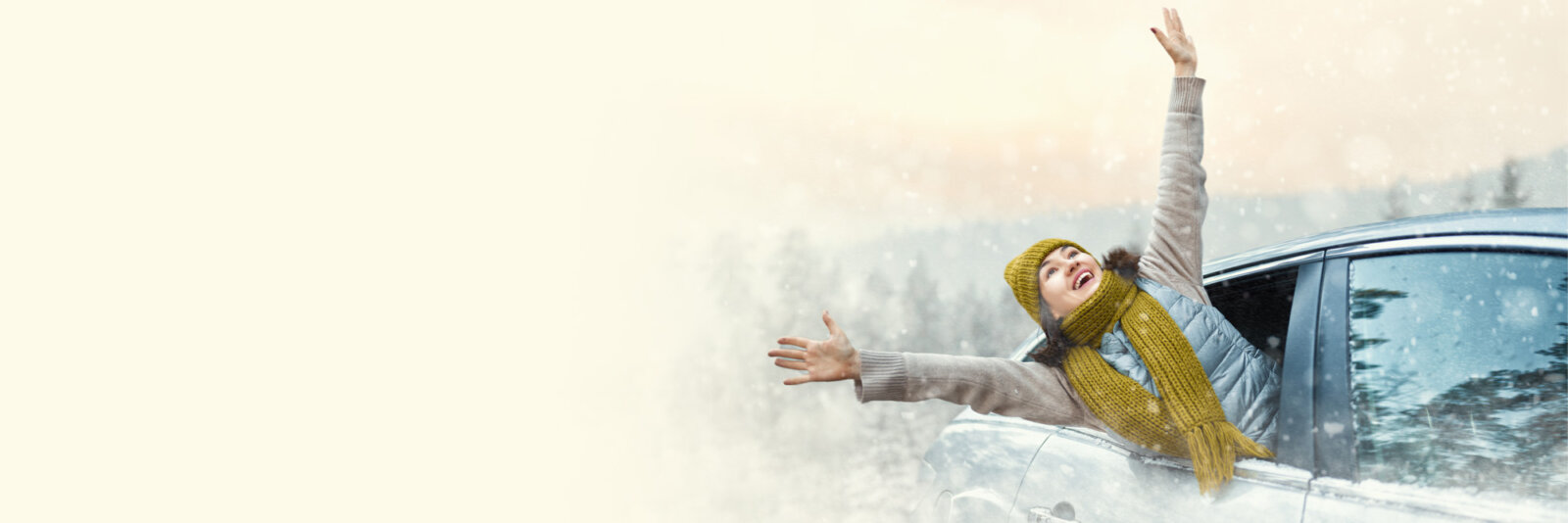 Excited Woman Arms Extended out of car on snowy day